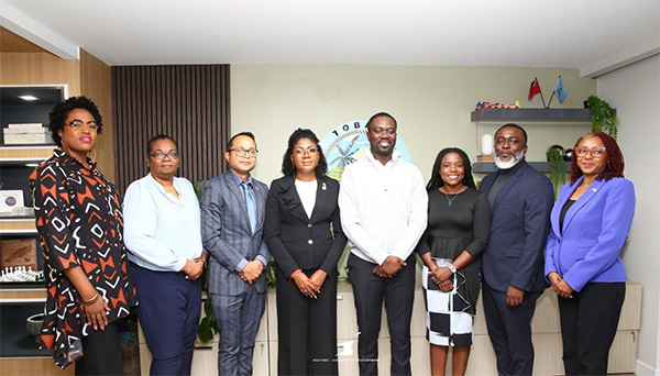 Photo 1: The Honourable Michelle Benjamin, Minister of Culture and Community Development (fourth from left) poses with The Honourable Farley Augustine, Chief Secretary of the Tobago House of Assembly (fifth from left), Dr. Narindra Roopnarine, Parliamentary Secretary in the Ministry of Culture and Community Development (third from left), Mrs. Gwyneth Morris-Alexander, Permanent Secretary (Ag.) in the Ministry of Culture and Community Development (second from left), Ms. Keiba Jacob-Mottley, CEO of NCC (first from left), Councillor Tashia Burris, Secretary for the Division of Tourism, Culture, Antiquities and Transportation (DOTCAT) (sixth from left), Assemblyman Niall George, Assistant Secretary (DOTCAT) (seventh from left) and Ms. Shelly Trim, Administrator (DOTCAT) (eighth from left) during her official visit to the Office of the Chief Secretary – THA on July 10, 2025.