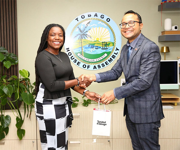 Photo 3: Dr. Narindra Roopnarine, Parliamentary Secretary in the Ministry of Culture and Community Development presents Councillor Tashia Burris, Secretary for the Division of Tourism, Culture, Antiquities and Transportation (DOTCAT) with a token during the official visit of the Minister of Culture and Community Development to the Office of the Chief Secretary – THA on July 10, 2025.