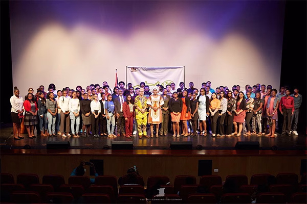 Photo 4: The Honourable Michelle Benjamin, Minister of Culture and Community Development (middle), along with Dr. Narindra Roopnarine, Parliamentary Secretary, and other Ministry officials, pose with the Trailblazers: National Youth Apprenticeship Community Development Programme 2025 cohort during the registration and orientation session, held at SAPA on July 28, 2025.