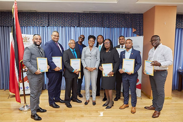 Photo 4: The Honourable Michelle Benjamin (fifth from left) poses with the newly appointed National Carnival Commission, Board of Commissioners: Mr. Peter Kanhai, Chairman (third from left), Mr. Kevan Gibbs, Deputy Chairman (second from left), Mr. Neil Iwer George (fourth from left), Mr. Imran Beharry (first from left), Mr. John Michael Ali Bocus (sixth from left), Mrs. Beverly Ramsey-Moore (seventh from left), Mr. Robert Abdool-Mitchell (eighth from left), Mr. Mark Ayen (ninth from left) and Mr. Ainsley King (tenth from left) during the presentation ceremony at the Ministry’s headquarters on Wednesday July 16, 2025.
